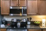 Cooking up a storm during your stay Look no further than our fully equipped kitchen. This photo showcases our stove, microwave, and ample kitchen utensils for all your culinary needs. Whether you`re whipping up a quick breakfast or preparing a gourmet di